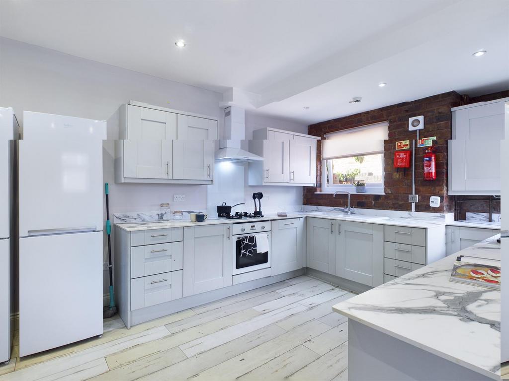 Bright and modern kitchen featuring ample stora...