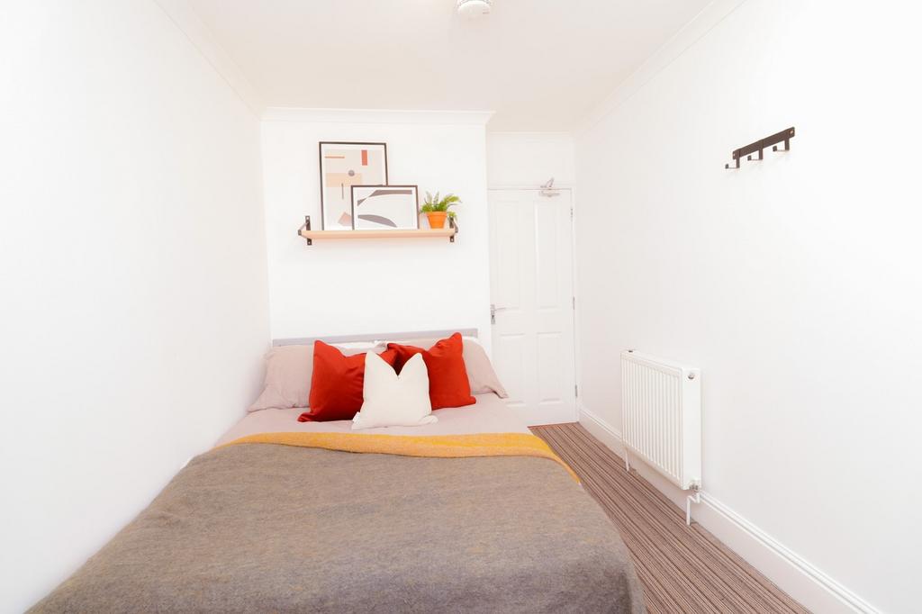A bright and inviting double bedroom featuring ...