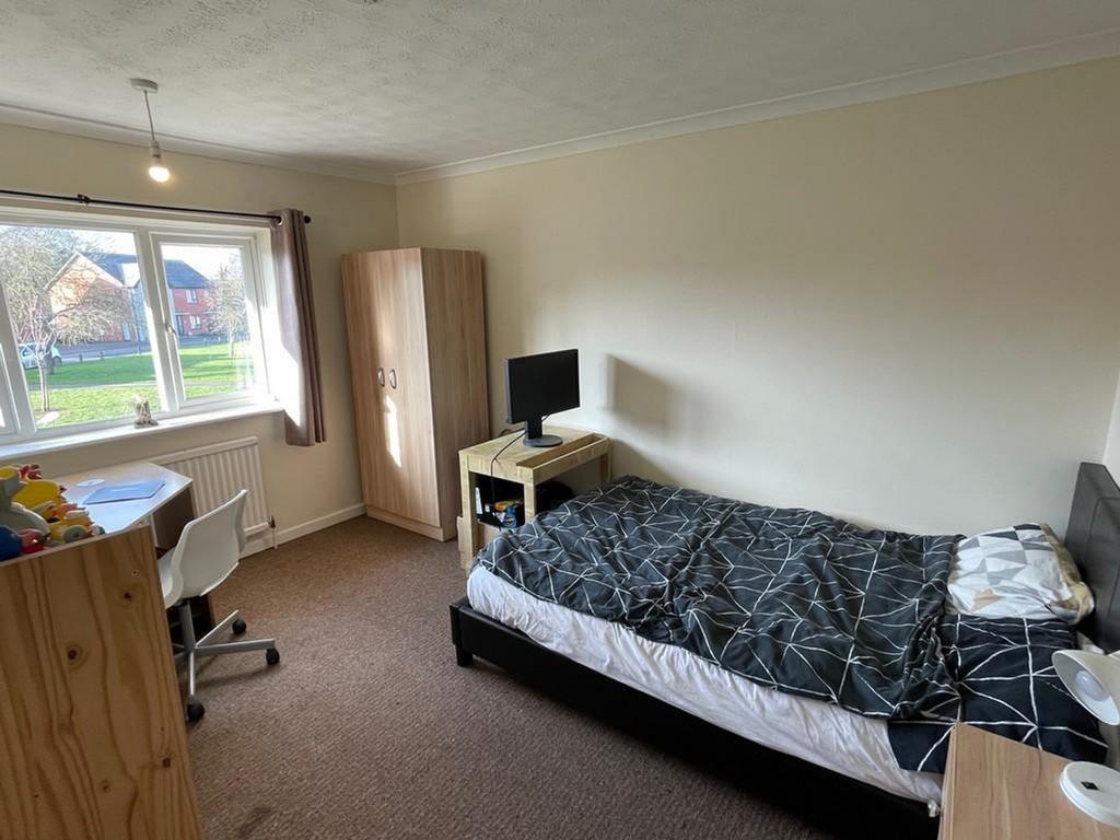 A spacious and bright double bedroom featuring ...