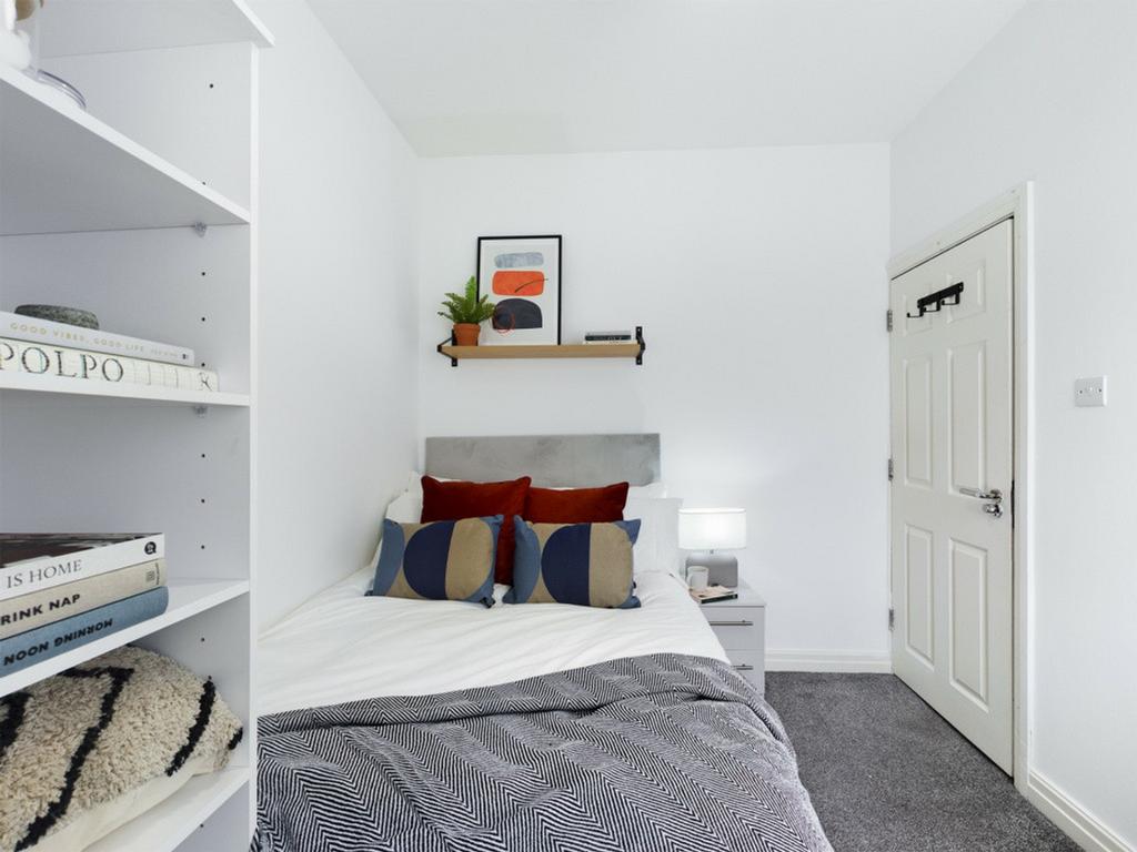 A tidy and well-decorated double bedroom featur...