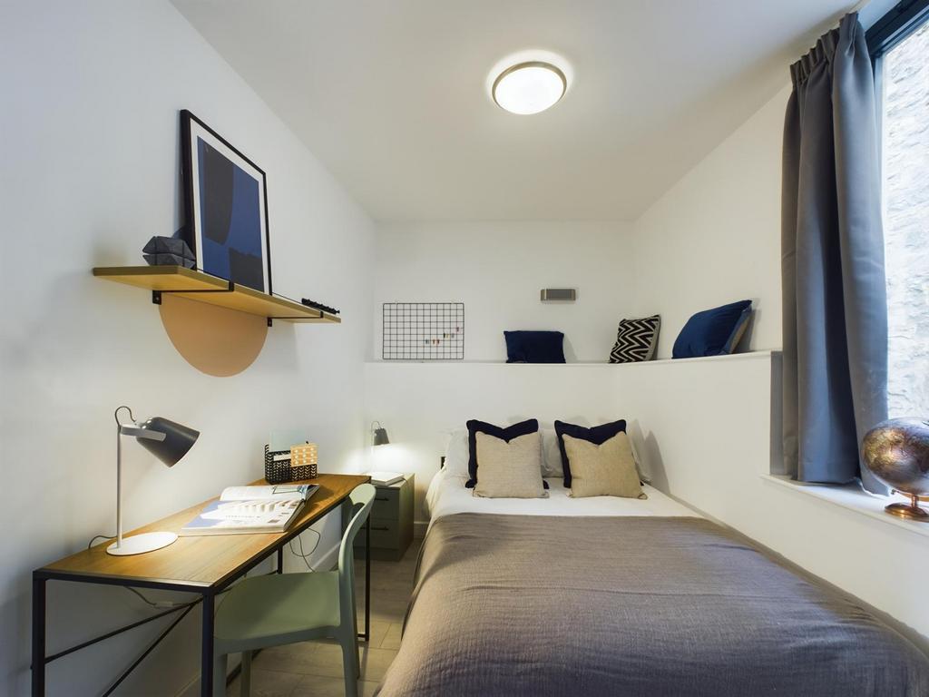 A bright and stylish double bedroom featuring a...