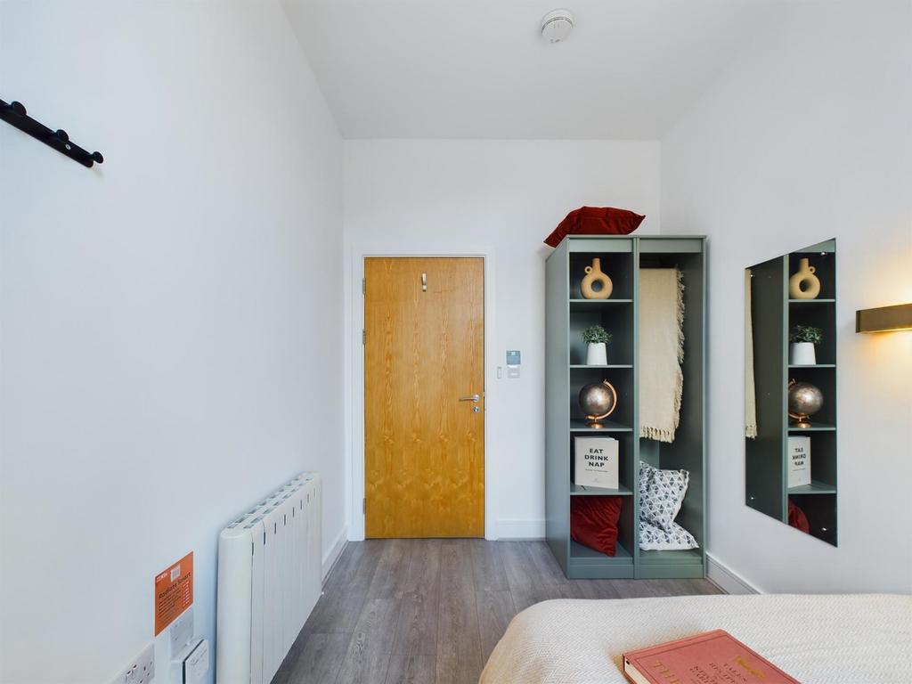 A bright and tidy double bedroom featuring styl...