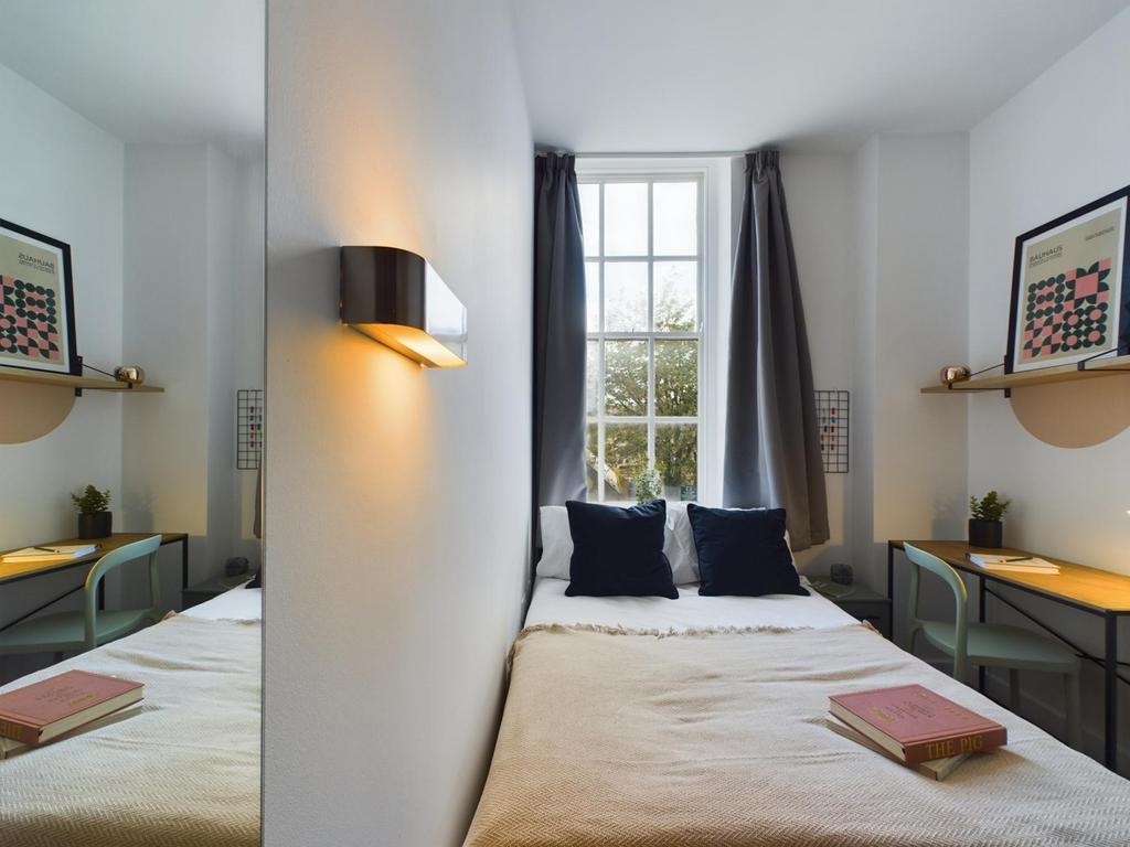 A bright and inviting double bedroom featuring ...