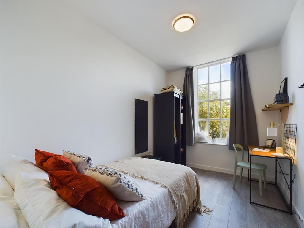 A bright and inviting double bedroom featuring ...