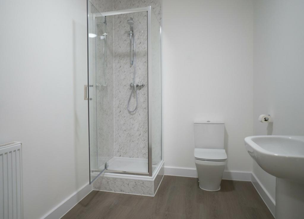 A modern bathroom featuring a stylish shower wi...