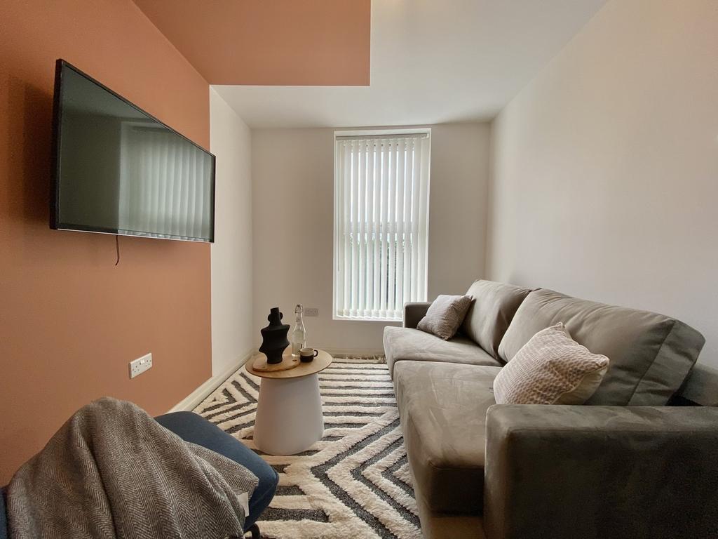 A cozy and inviting living room with ample natu...