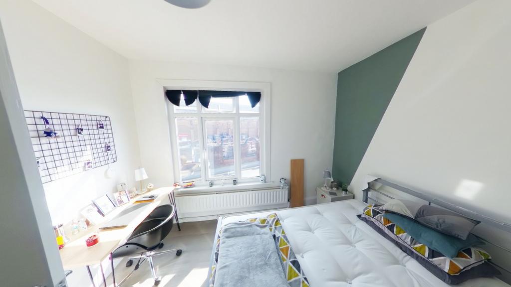 A spacious and bright double bedroom featuring ...