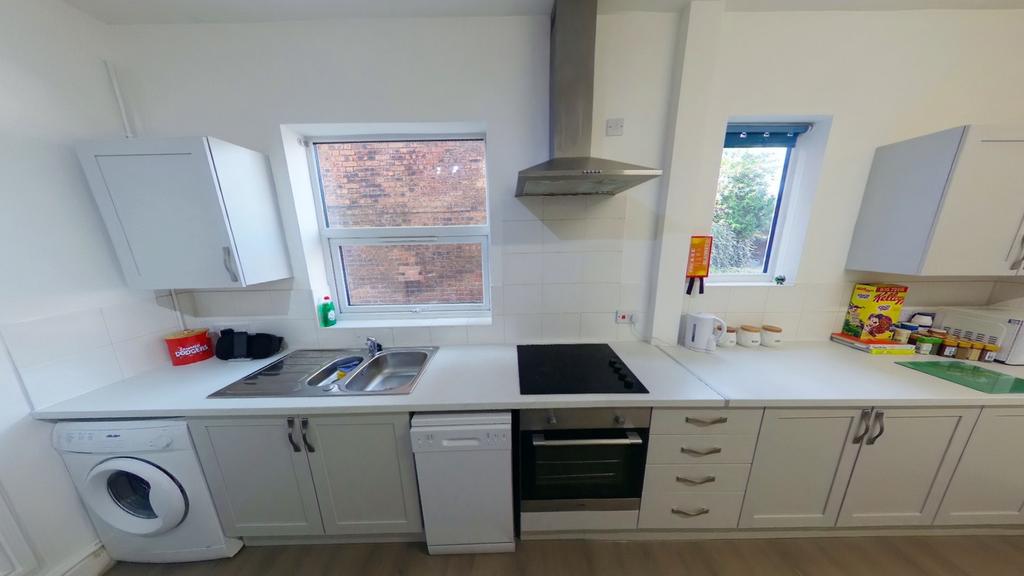 A bright and modern kitchenette equipped with e...