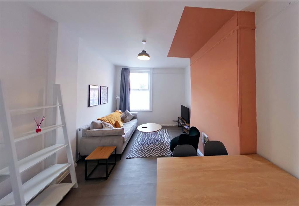 A spacious and stylish modern living room featu...