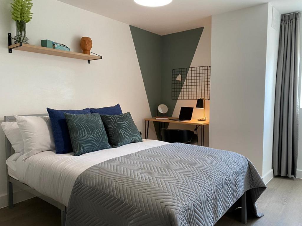A well-presented bedroom featuring a comfortabl...