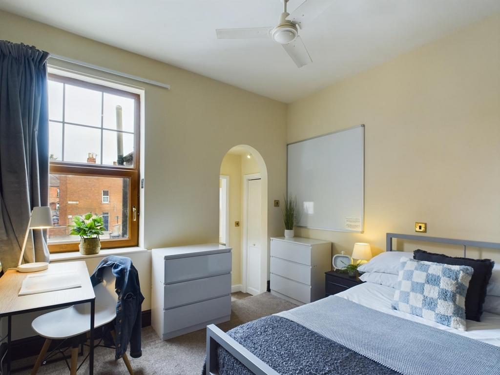 A bright and inviting double bedroom featuring ...