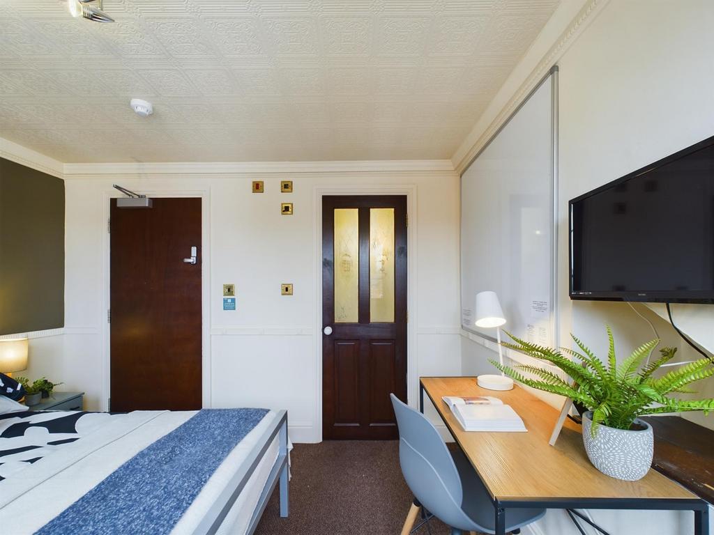 A bright and inviting double bedroom featuring ...