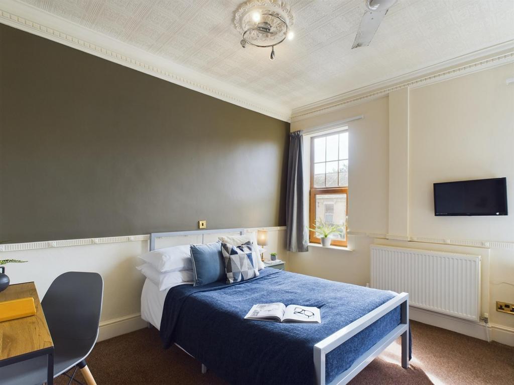 A stylish and inviting double bedroom with ampl...