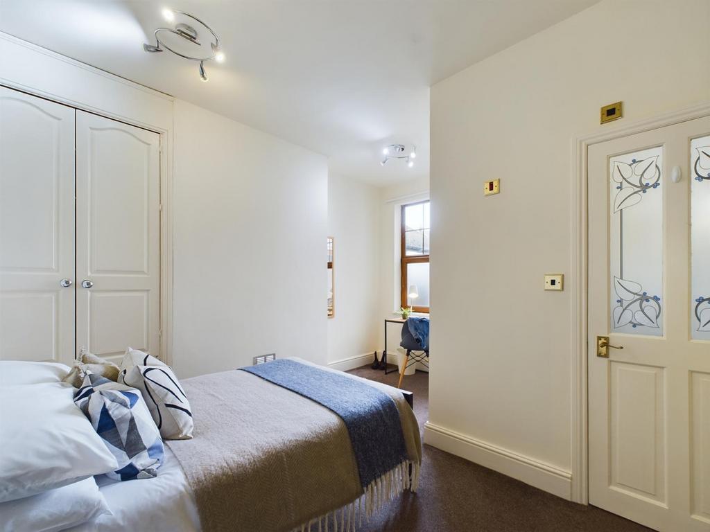A bright and inviting double bedroom featuring ...
