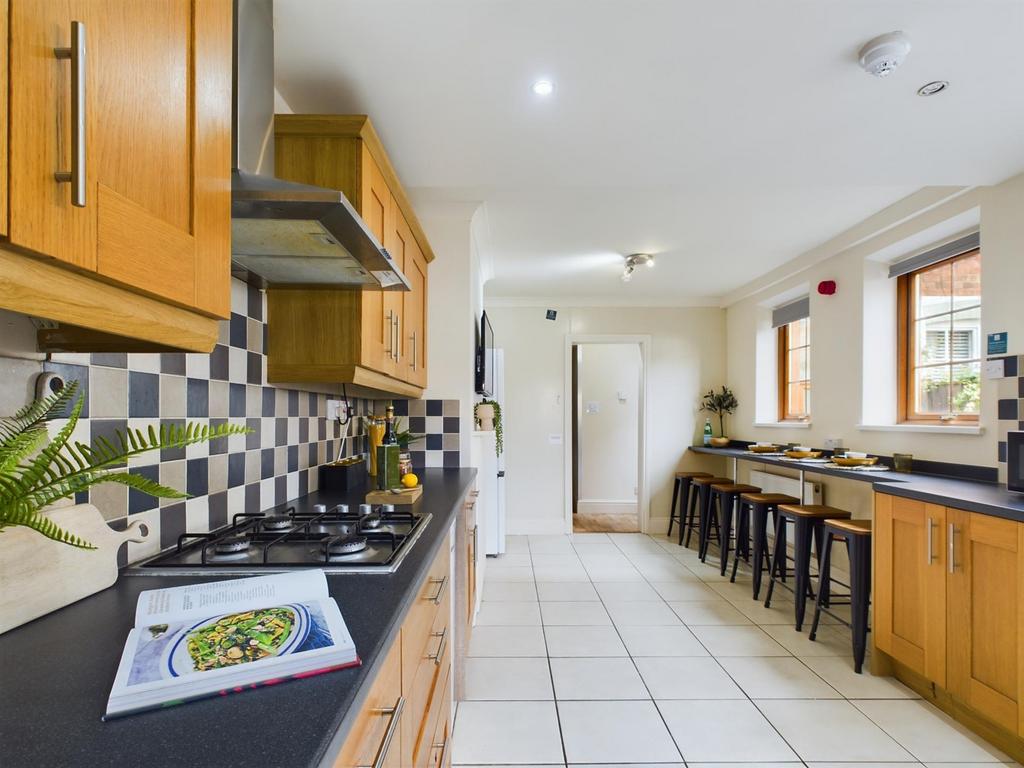 A spacious and modern kitchen with ample natura...