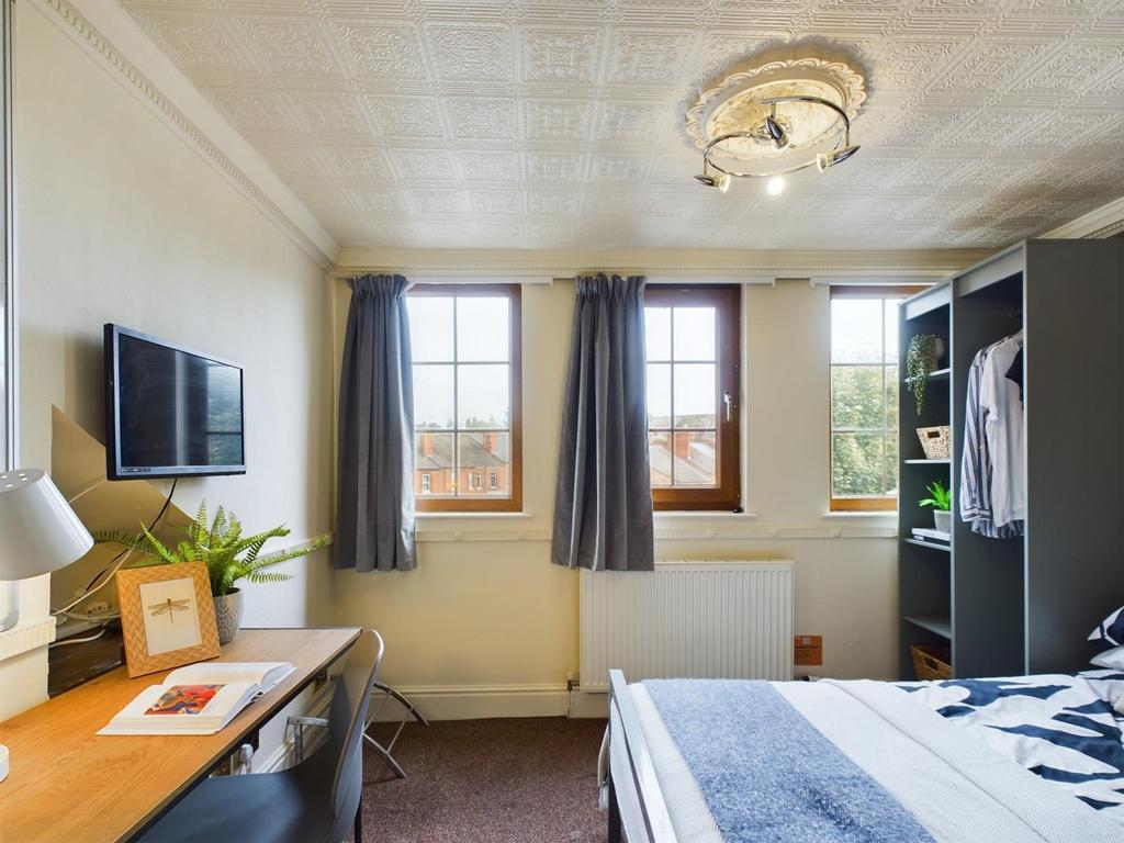 A bright and inviting double bedroom featuring ...