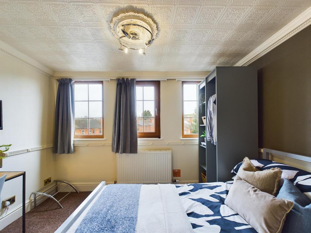 A bright and inviting double bedroom featuring ...