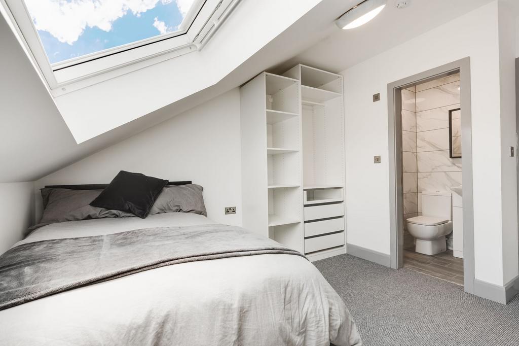 Bright and modern master bedroom with a large s...