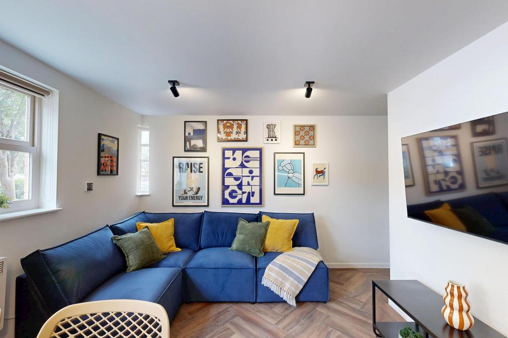 A bright and welcoming living room featuring a ...