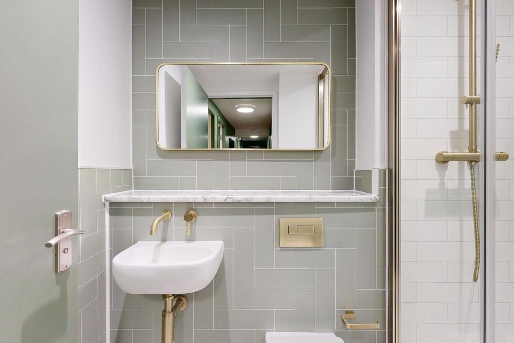 A clean and modern bathroom featuring a large s...