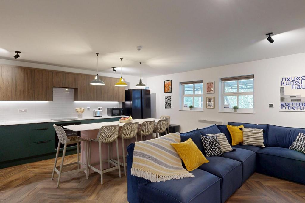 Bright, modern open-plan lounge with a deep blu...