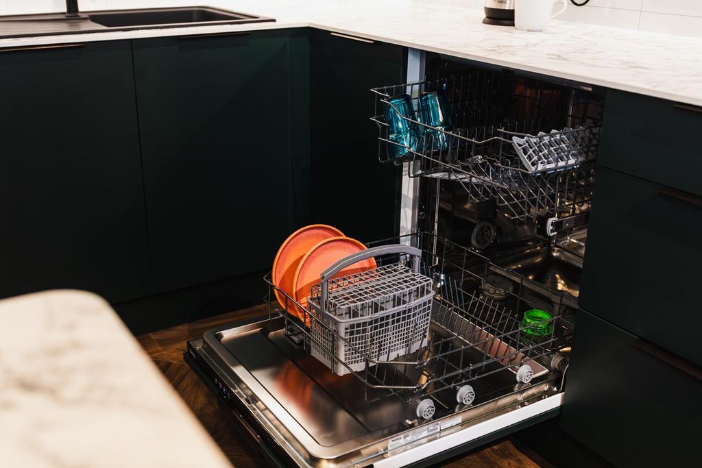 Modern kitchen with an open built-in dishwasher...