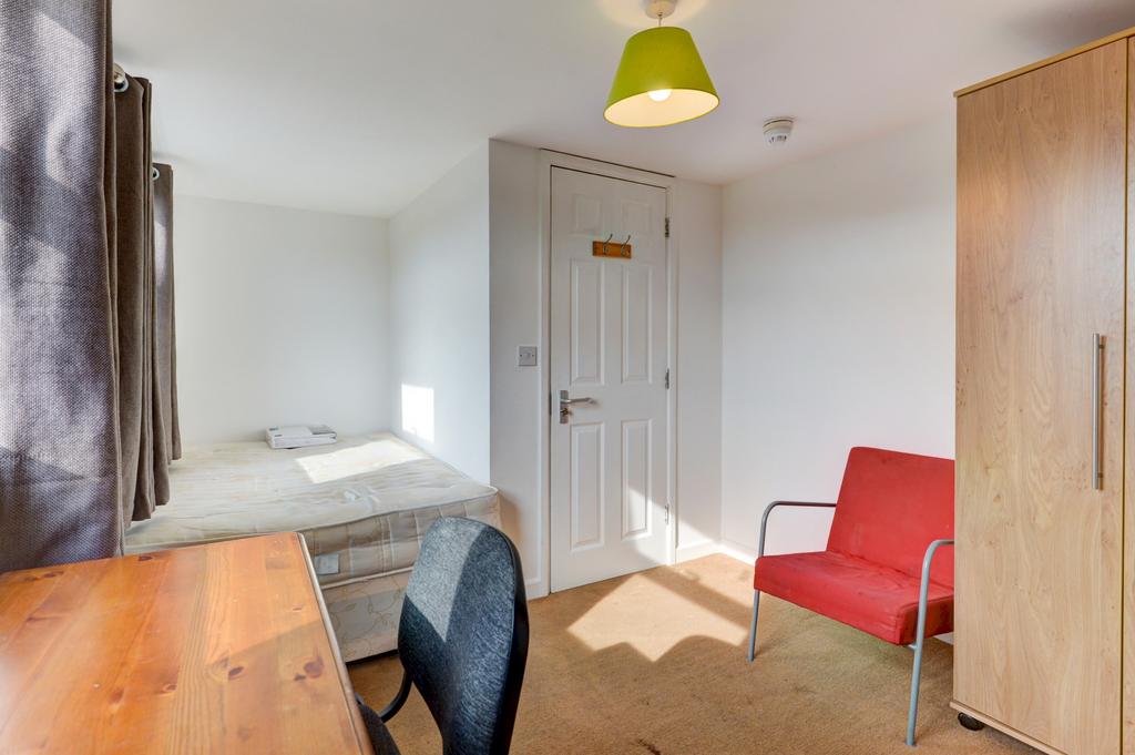 A bright and well-maintained bedroom featuring ...