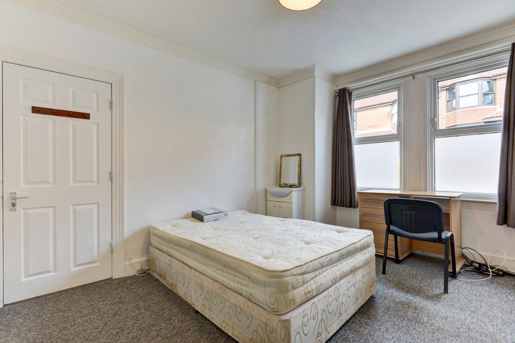 A bright and clean student bedroom featuring a ...