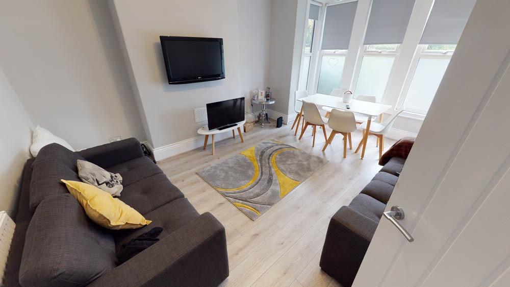 A bright and welcoming living room featuring a ...