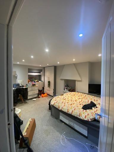 Spacious master bedroom featuring a large bed w...