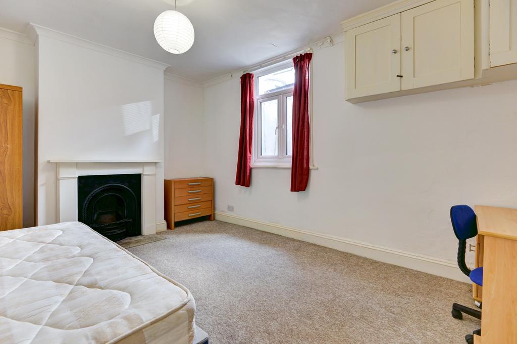 A bright and clean single bedroom featuring a w...