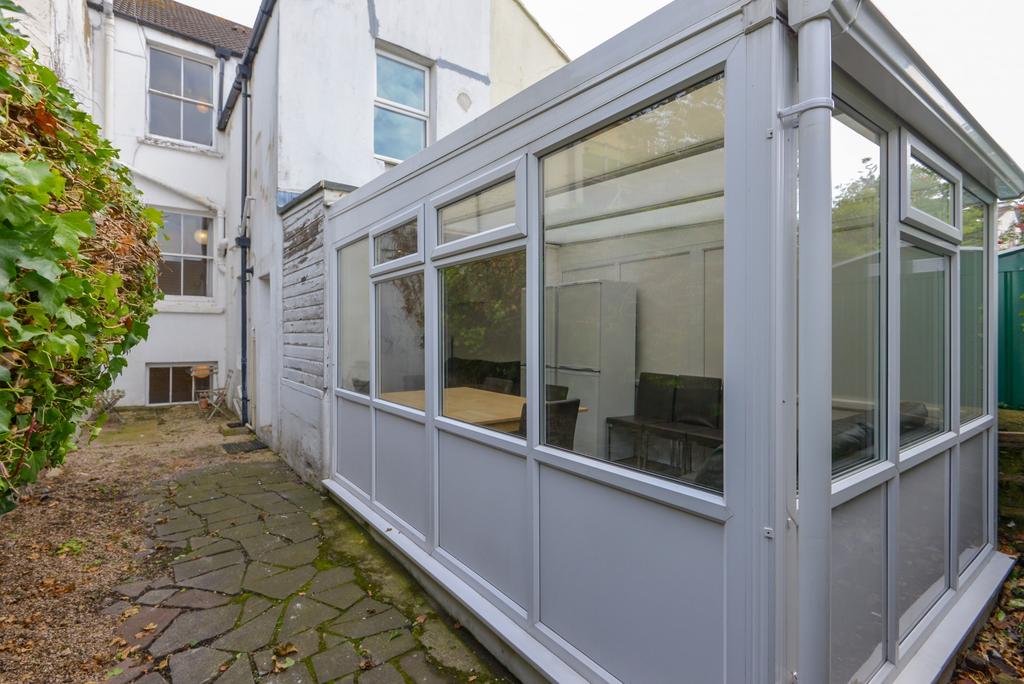 A well-maintained garden area featuring a paved...