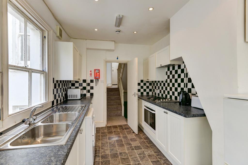 Bright and tidy kitchen featuring modern checke...