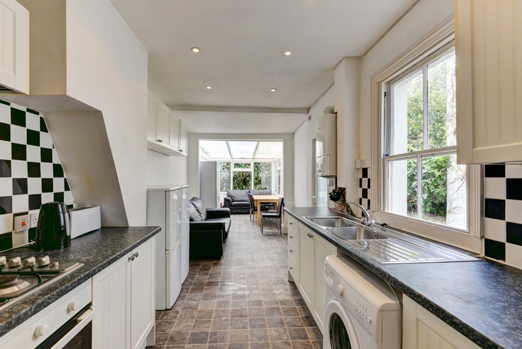 Bright and airy kitchen featuring a spacious la...
