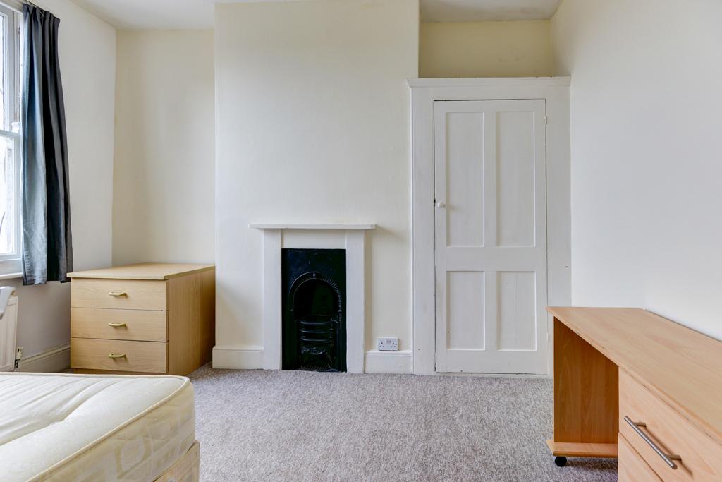 Bright and tidy small room with clean white wal...