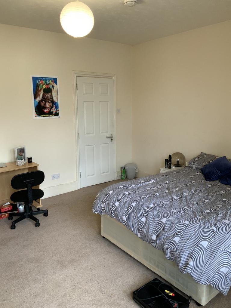 A cozy double bedroom featuring a neatly made b...