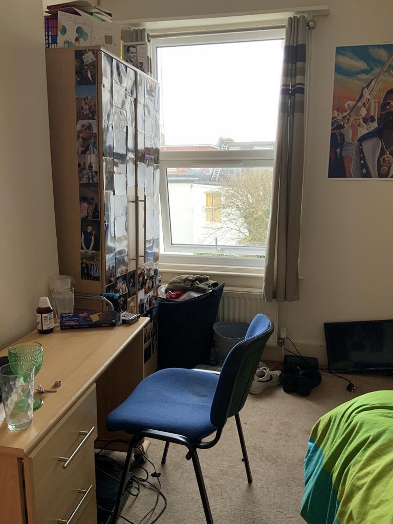 A modest-sized living room with a window allowi...