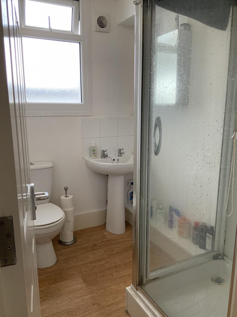 A bright and clean bathroom featuring a shower ...