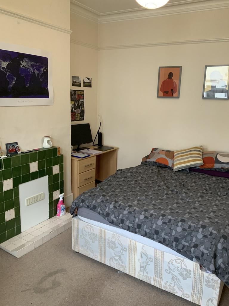 A comfortable double bedroom featuring a large ...