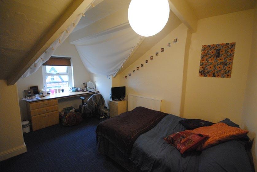 A cozy bedroom with a large double bed, featuri...
