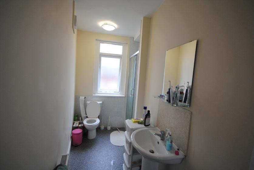 A well-maintained bathroom with a large window ...