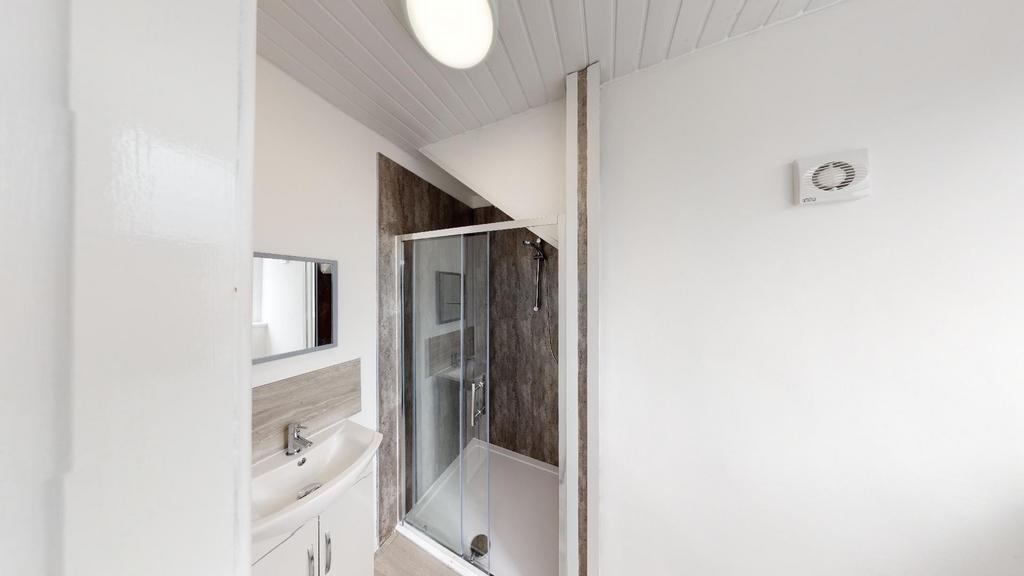 A modern bathroom featuring a shower enclosure,...