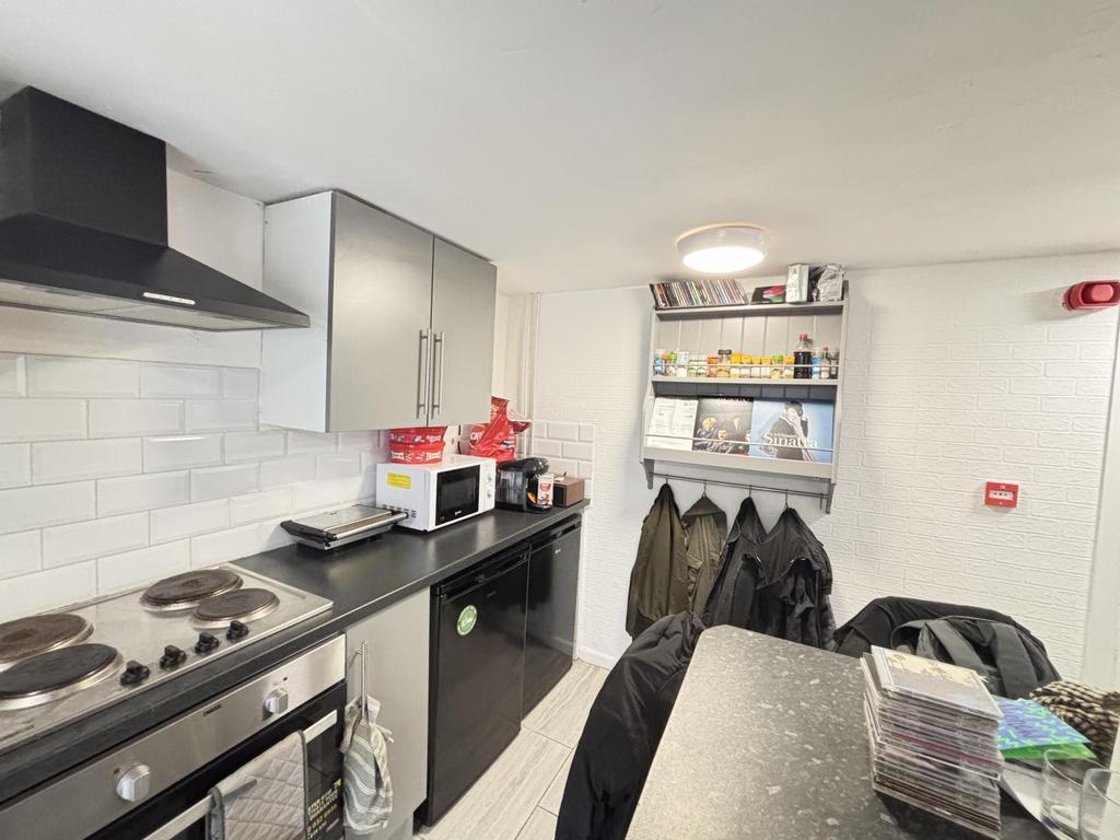 A modern, well-maintained kitchen with ample wo...