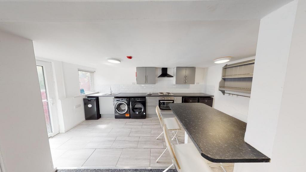 A modern, well-lit kitchen with ample counter s...
