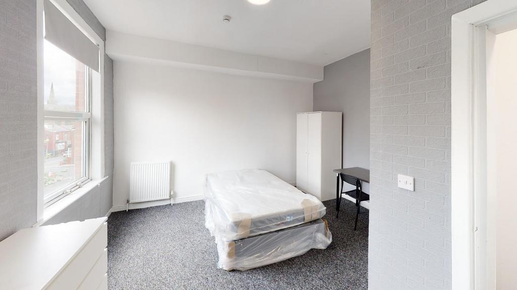A bright and welcoming double bedroom with natu...
