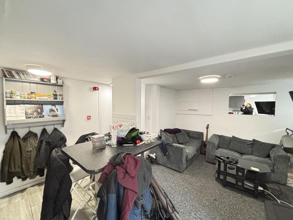 A spacious and modern living room featuring com...