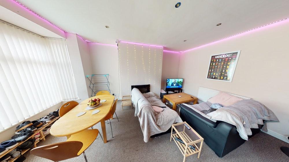 A bright and inviting living room featuring com...