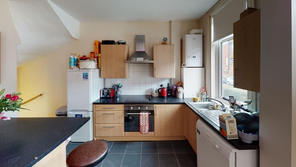 A modern, well-lit kitchen with ample counter s...