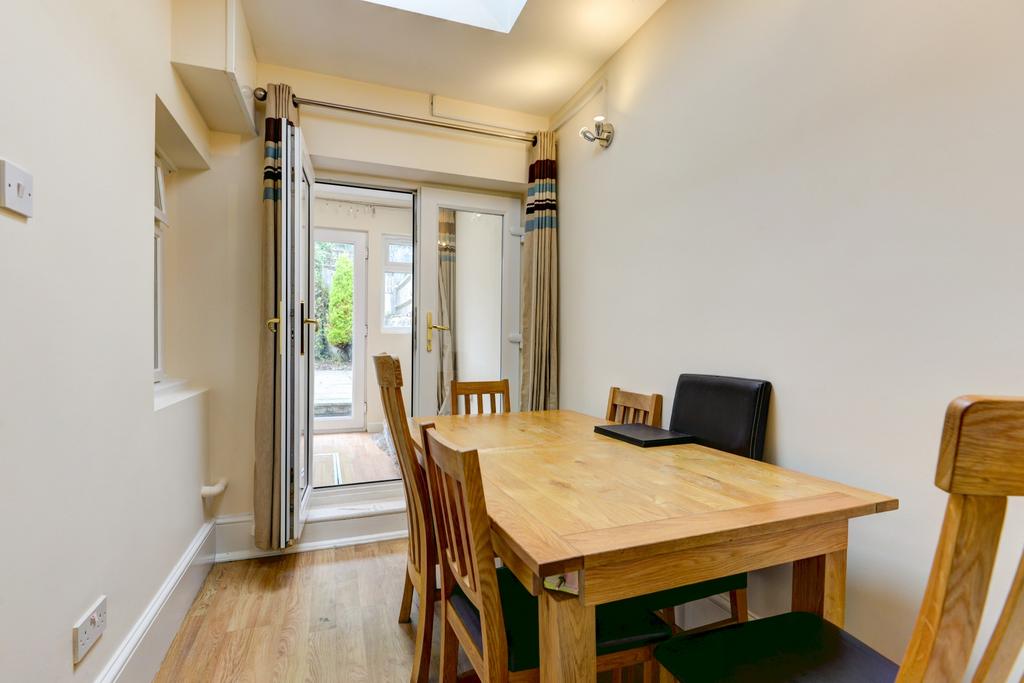 A bright and welcoming dining area with a woode...