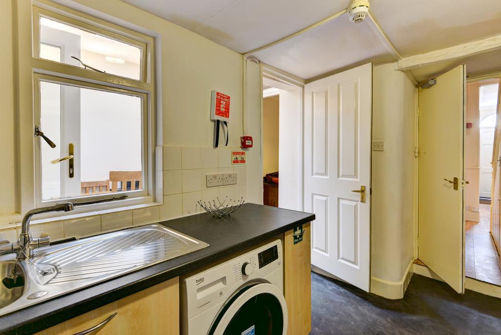 A functional kitchen area featuring a sink, cou...